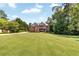 Spacious two-story home with a sprawling front lawn and mature trees at 7125 Heard Rd, Cumming, GA 30041