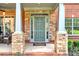 Inviting front porch with stone accents and comfortable seating area at 7125 Heard Rd, Cumming, GA 30041
