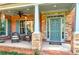 Charming front porch with stone pillars and cozy seating for relaxation at 7125 Heard Rd, Cumming, GA 30041
