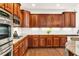 Gourmet kitchen features custom cabinets, granite countertops, stainless steel appliances, and a stylish backsplash at 7125 Heard Rd, Cumming, GA 30041