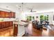 Spacious kitchen open to dining and living area features a granite island with seating, stainless appliances, and natural light at 7125 Heard Rd, Cumming, GA 30041