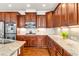 Kitchen with stainless steel appliances, granite countertops, and cherry cabinets at 7125 Heard Rd, Cumming, GA 30041