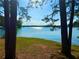 Tranquil lake view framed by trees, perfect spot for relaxing with nature at 7125 Heard Rd, Cumming, GA 30041