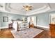 Spacious main bedroom with tray ceilings, hardwood floors, and access to an en-suite bathroom at 7125 Heard Rd, Cumming, GA 30041