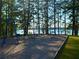 Lakeside playground with swings surrounded by tall trees, a great Gathering amenity at 7125 Heard Rd, Cumming, GA 30041