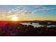 Breathtaking aerial sunset over the lake, highlighting the serene water and tree-lined shores at 7125 Heard Rd, Cumming, GA 30041