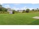 Spacious backyard with green grass and a storage shed at 8553 Braylen Manor Dr, Douglasville, GA 30134