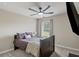 Comfortable bedroom featuring neutral walls, a ceiling fan, and plush carpeting at 8553 Braylen Manor Dr, Douglasville, GA 30134