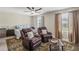 Relaxing bedroom featuring comfortable seating, ceiling fan, and natural light from the window at 8553 Braylen Manor Dr, Douglasville, GA 30134