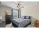 Well-lit bedroom featuring a patterned bedspread and matching curtains at 8553 Braylen Manor Dr, Douglasville, GA 30134