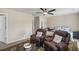 Comfortable bedroom featuring two recliners, ceiling fan, and natural light from the window at 8553 Braylen Manor Dr, Douglasville, GA 30134