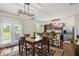Dining area features a modern light fixture and stainless steel appliances in the kitchen at 8553 Braylen Manor Dr, Douglasville, GA 30134