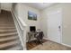 Entryway view featuring hardwood floors, stairs, and a workstation with natural light at 8553 Braylen Manor Dr, Douglasville, GA 30134