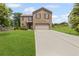 Inviting two-story brick home with a well-manicured lawn and a spacious driveway at 8553 Braylen Manor Dr, Douglasville, GA 30134