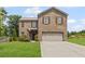 Inviting two-story brick home with a well-manicured lawn and a spacious driveway at 8553 Braylen Manor Dr, Douglasville, GA 30134