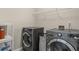 Spacious laundry room with modern washer and dryer, and shelving for storage at 8553 Braylen Manor Dr, Douglasville, GA 30134