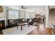 Living room featuring wood flooring, fireplace, and a view of the kitchen at 8553 Braylen Manor Dr, Douglasville, GA 30134