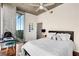 Bedroom with a large window view of the city skyline, concrete ceiling, and wood floors at 860 Peachtree Ne St # 2001, Atlanta, GA 30308