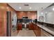 Modern kitchen featuring stainless steel appliances, dark cabinets, and granite countertops and hardwood flooring at 860 Peachtree Ne St # 2001, Atlanta, GA 30308