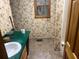 Bathroom featuring wallpaper, tile floors, a sink, and a toilet at 245 Jesse Mccollum Dr, Canton, GA 30114