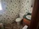 Bathroom showcasing floral wallpaper, a toilet, and a sink at 245 Jesse Mccollum Dr, Canton, GA 30114