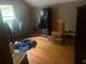 Bedroom features hardwood floors and natural light from a window at 245 Jesse Mccollum Dr, Canton, GA 30114