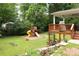 Spacious backyard with playset, deck, and landscaped garden, perfect for outdoor activities at 5070 Hensley Dr, Atlanta, GA 30338