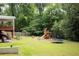 Large backyard featuring a playset with slide and swing set, and a trampoline at 5070 Hensley Dr, Atlanta, GA 30338