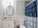 Stylish bathroom featuring a white vanity with a marble countertop and a decorative shower curtain at 5070 Hensley Dr, Atlanta, GA 30338