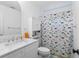 Well-lit bathroom featuring a dinosaur-themed shower curtain and white marble countertops at 5070 Hensley Dr, Atlanta, GA 30338