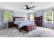 Spacious primary bedroom with a ceiling fan, soft blue walls, and lots of natural light at 5070 Hensley Dr, Atlanta, GA 30338