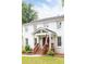 Charming two-story white brick home with inviting front porch and well-manicured lawn at 5070 Hensley Dr, Atlanta, GA 30338