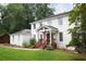 Beautiful two-story white home with a well-kept lawn and an inviting front porch with wood stairs at 5070 Hensley Dr, Atlanta, GA 30338