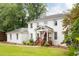 Beautiful two-story white brick home with inviting front porch and well-manicured lawn at 5070 Hensley Dr, Atlanta, GA 30338