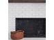 A traditional white brick fireplace featuring a dark mantel, basket and black firebox at 5070 Hensley Dr, Atlanta, GA 30338