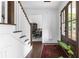 Bright foyer featuring hardwood floors, staircase, and a view into the dining room at 5070 Hensley Dr, Atlanta, GA 30338