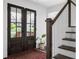 Elegant foyer featuring hardwood floors, staircase, and a wood framed door at 5070 Hensley Dr, Atlanta, GA 30338