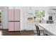 Modern kitchen features white cabinets, updated appliances, an island, and backyard access at 5070 Hensley Dr, Atlanta, GA 30338