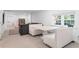 A modern living area with white booth seating, a gray sofa, and a view of the entryway at 5070 Hensley Dr, Atlanta, GA 30338