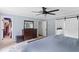 Well-lit bedroom with ensuite bath, walk-in closet, a dark wood dresser, and light-blue walls at 5070 Hensley Dr, Atlanta, GA 30338