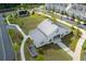 Aerial view of community barn with concert green space, surrounded by sidewalks, parking, and townhomes at 579 Brashy St, Woodstock, GA 30188