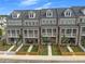 Overhead shot of townhomes with brick facades, balconies, private yard, picket fences and walkways at 579 Brashy St, Woodstock, GA 30188