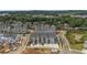 Aerial view of a residential area featuring townhomes, a pond and trees surrounding the neighborhood at 579 Brashy St, Woodstock, GA 30188