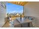 Outdoor patio features a dining table with seating, grill and a view of the neighborhood at 579 Brashy St, Woodstock, GA 30188