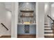 Stylish bar area with blue cabinetry, open shelving, and a chevron backsplash at 579 Brashy St, Woodstock, GA 30188