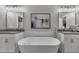 Serene bathroom featuring a modern tub, dual vanities, and stylish lighting at 579 Brashy St, Woodstock, GA 30188