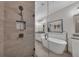 Modern bathroom featuring a glass shower and freestanding tub with elegant fixtures and stylish decor at 579 Brashy St, Woodstock, GA 30188