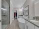 Elegant bathroom with a glass shower, soaking tub, and double vanities at 579 Brashy St, Woodstock, GA 30188