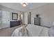 Cozy bedroom featuring soft carpet, calm gray walls, and modern furnishings with a decorative blanket on the bed at 579 Brashy St, Woodstock, GA 30188