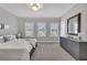 Bright bedroom with neutral tones, carpet, and a large window offering ample natural light and street views at 579 Brashy St, Woodstock, GA 30188
